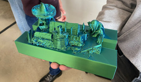 A green 3D diorama of the Three Witches hovering over the future kingdom in night storm from Macbeth