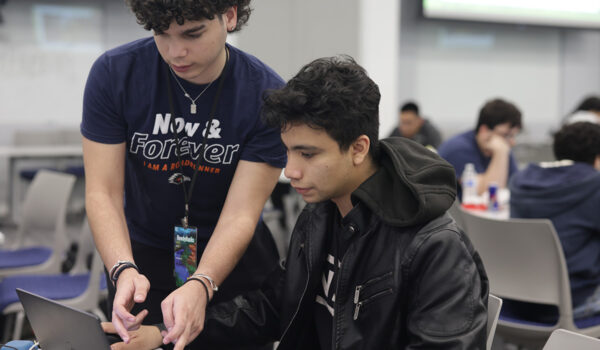 two students looking at a computer