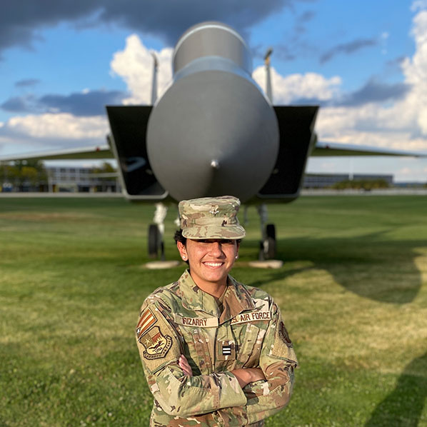 Sophia Irizarry poses for a photo in front of a fighter jet