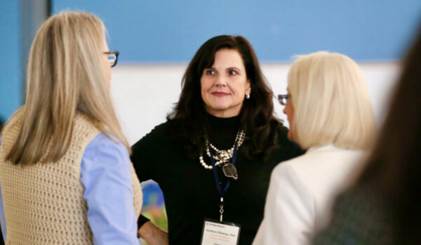 three women talking at conference