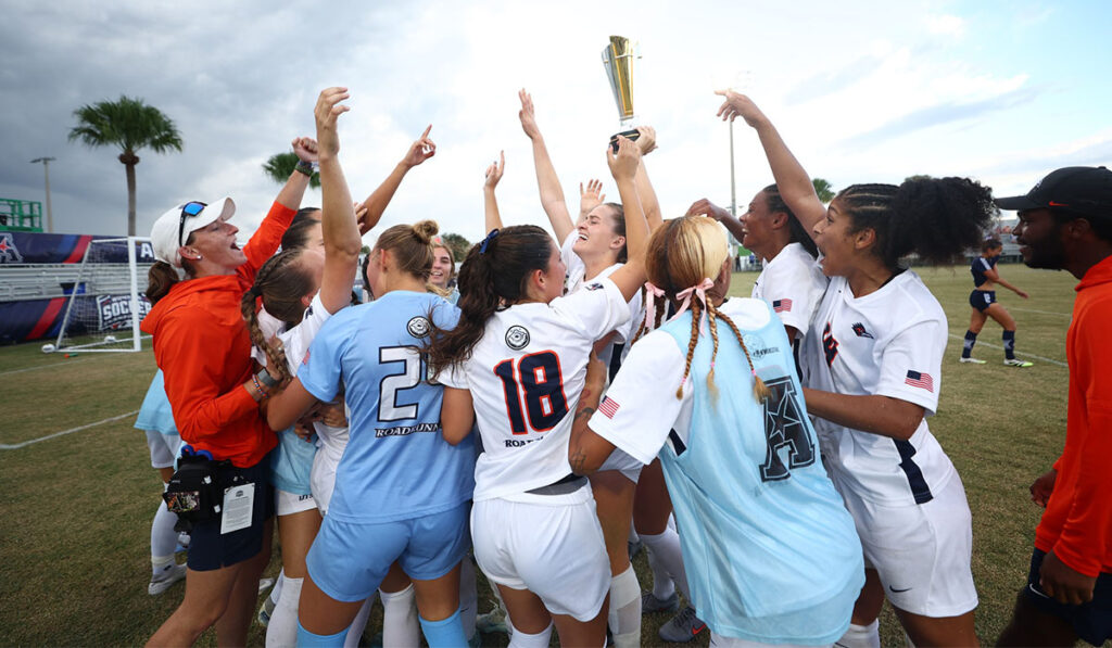 The UTSA soccer team celebrates with the conference tournament trophy