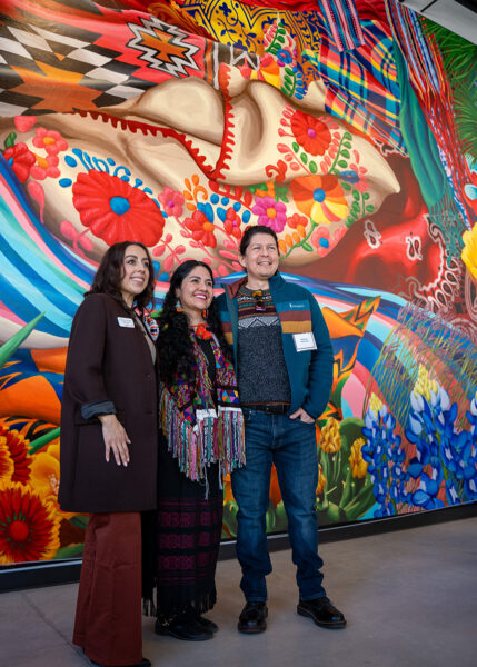 Visitors to the museum with the "Texas Tapestries" mural.
