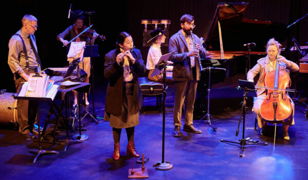The six members of Eighth Blackbird perform their instruments on stage