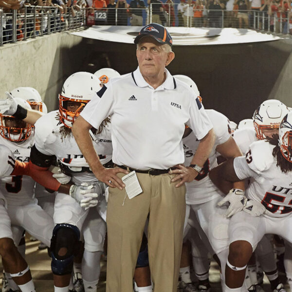 Coach Larry Coker stands in front of the UTSA football team just before they run onto the field
