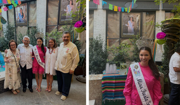 A woman in a pink dress and "Miss Fiesta" sash smiles with family in a festive setting, decorated with colorful banner.