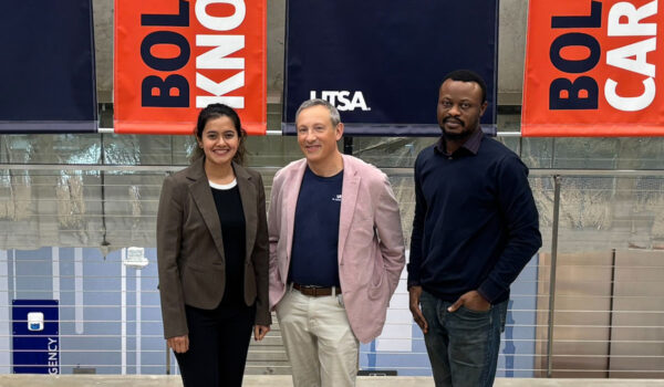 Three people stand in front of colorful banners that read "BOLD KNOWLEDGE" and "BOLD CARE."