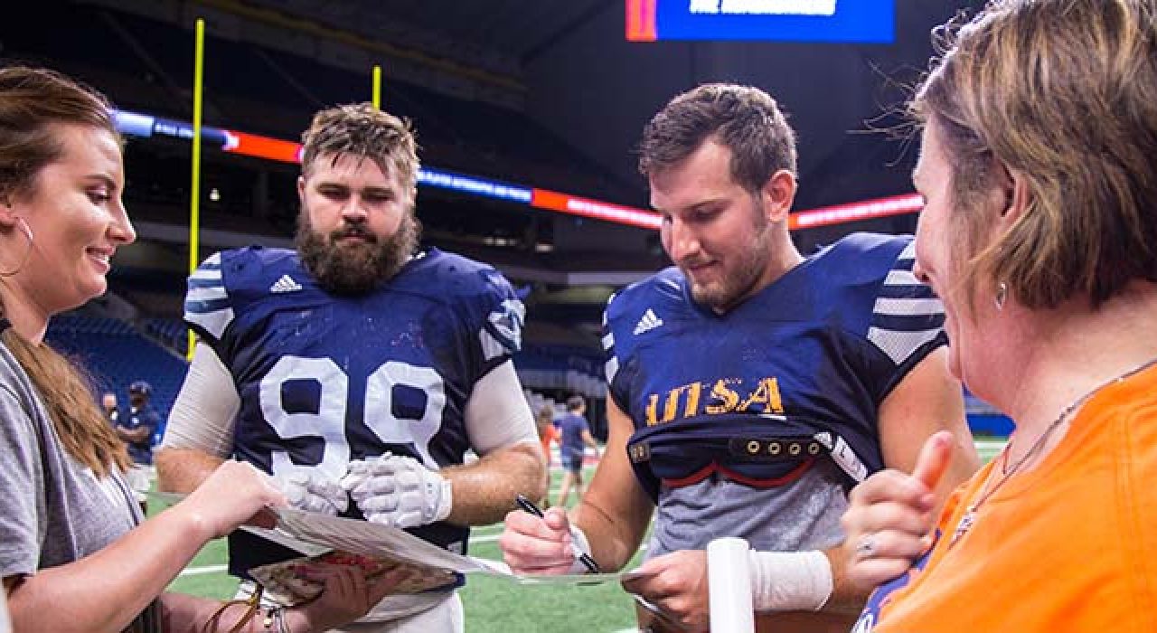 UTSA seniors Baylen Baker and Andrew Martel sign autographs at 2018 Fan Day. Photo credit: Vashaun Newman