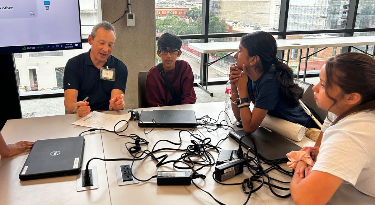 Interim Dean Fred Martin engages students in a group discussion, part of a four-day summer camp introducing middle schoolers to artificial intelligence concepts.