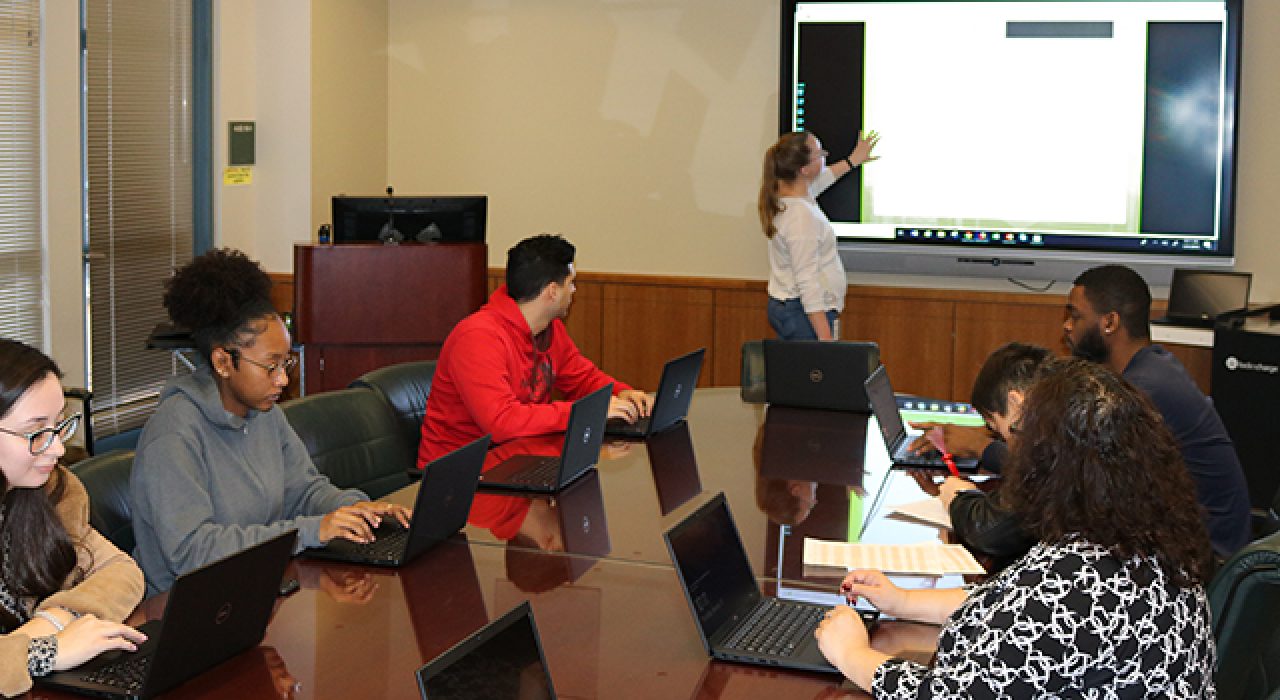 A UTSA student shows birds up for a PSA video created in the College of Education and Human Development’s Digital Technology Learning Labs.