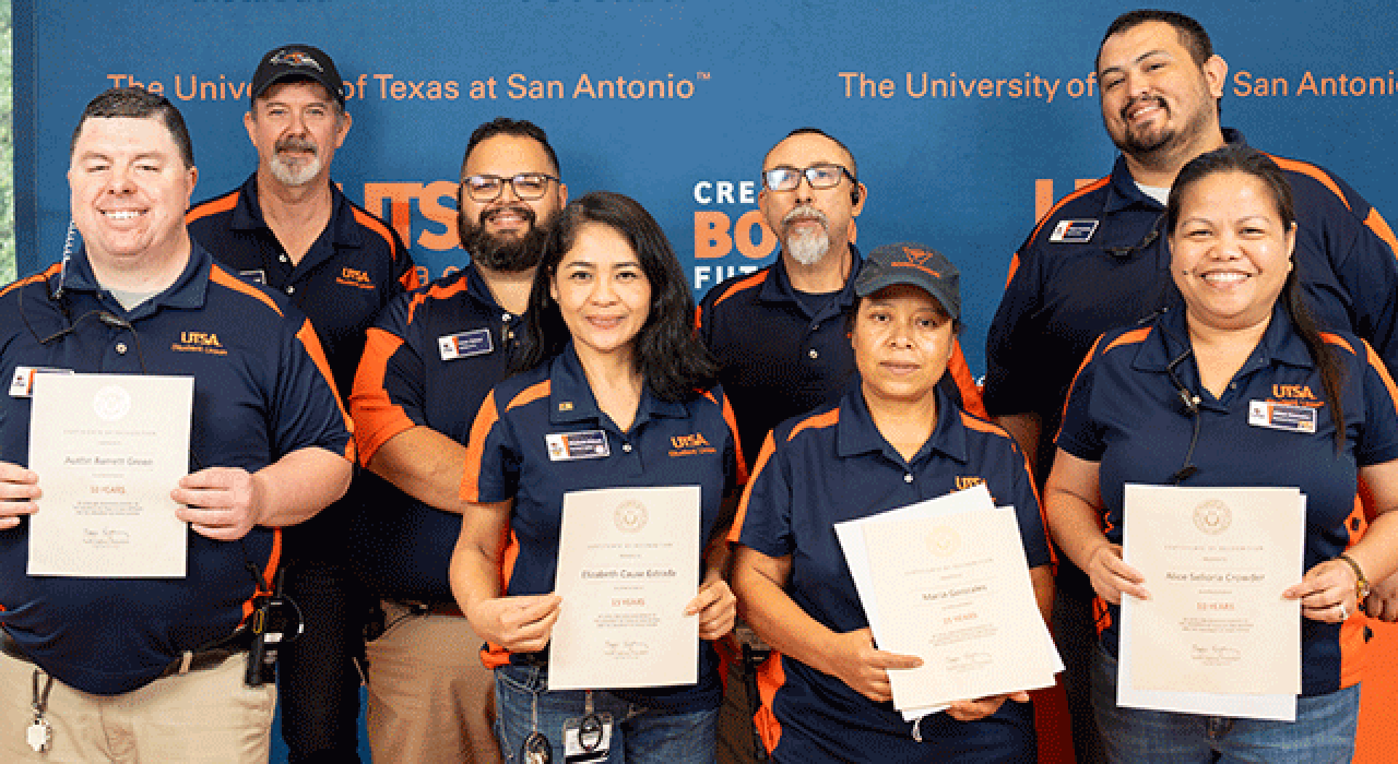 Faculty member Richard Anantua (right) accepts a Research Achievement Award alongside UTSA President Taylor Eighmy.
