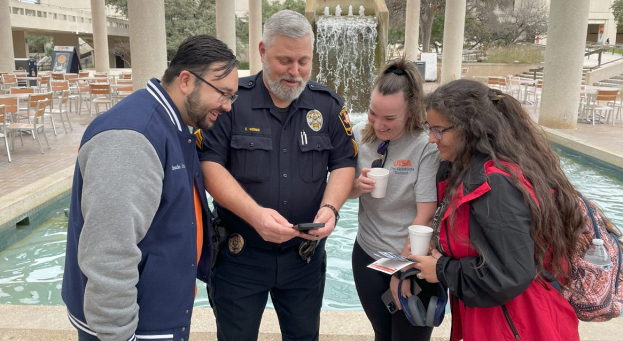 UTSAPD Sgt. Eric Weber showing Roadrunners how to use the SafeZone app.