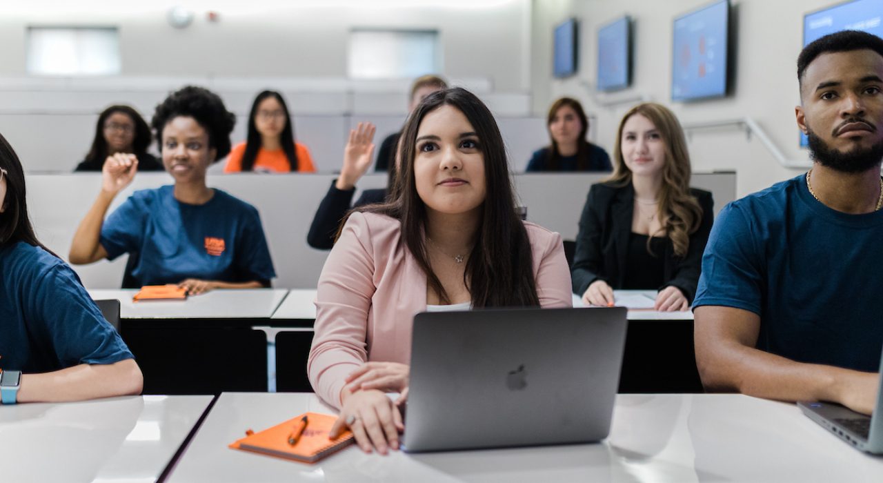 business students in class with laptops