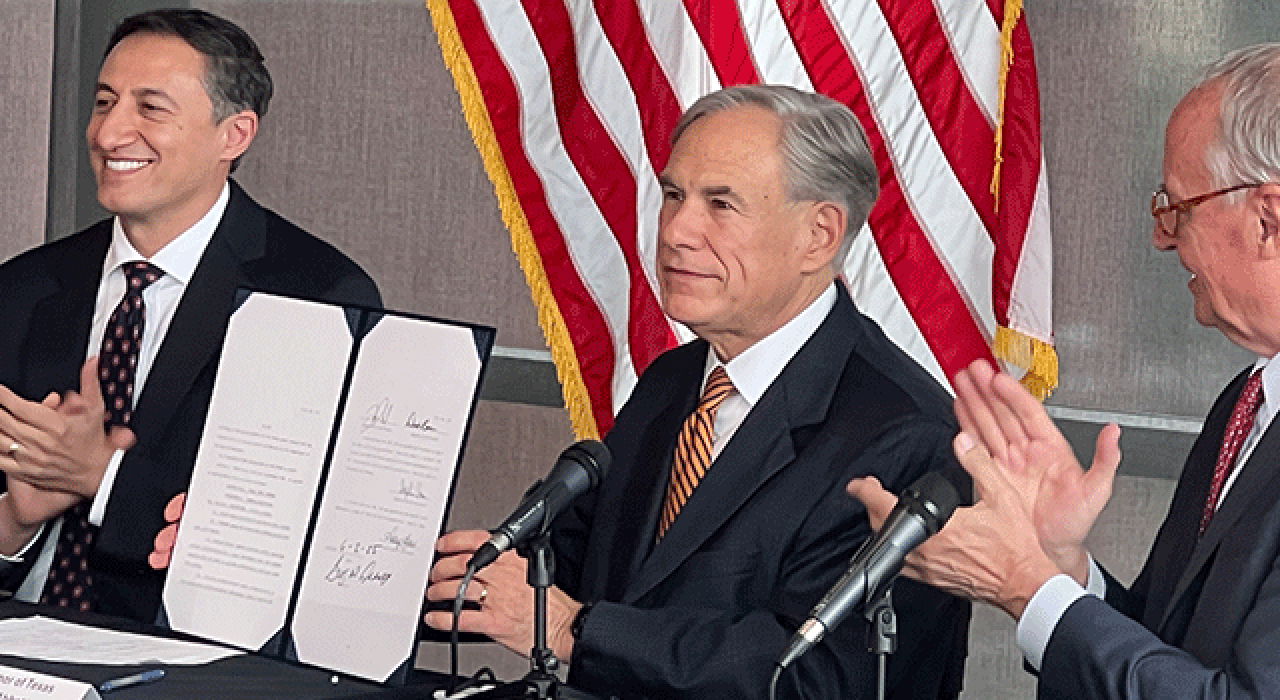 Gov. Greg Abbott signs the bill to create the Texas Cyber Command with Rep. Giovanni Capriglione (left) and President Taylor Eighmy (right) on Monday.