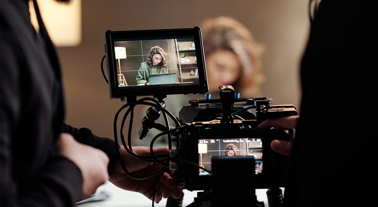 film-media-studies-behind-camera A camera display shows a woman in her office