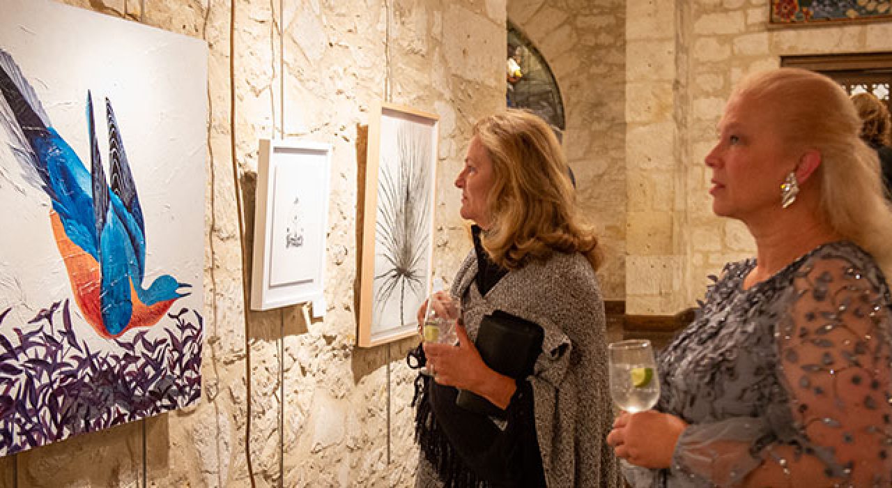 Patrons look at pieces of art during the Gala in the Garden's art sale.