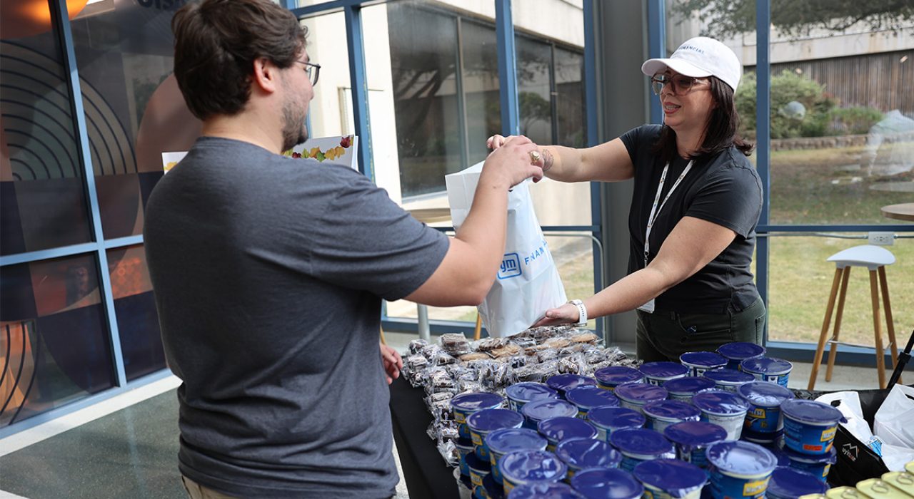 UT San Antonio student receives a Thanksgiving meal kit at a food distribution event.