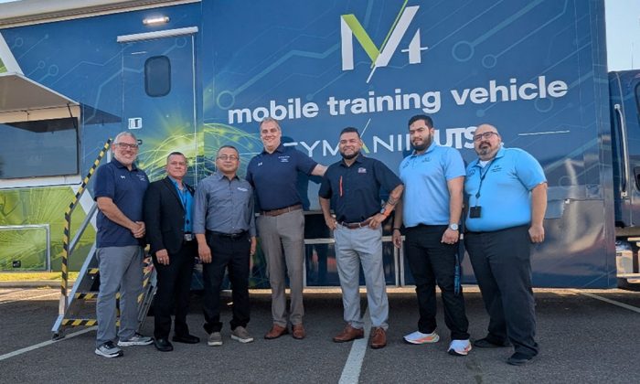 A group of men stand beside each other for a group photo.