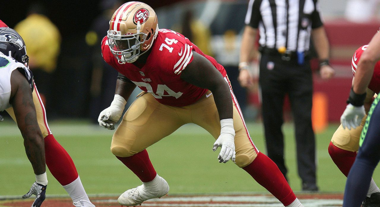 Spencer Burford prepares to block a Seattle Seahawks defender