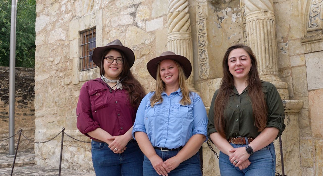 Gabriella Zaragosa, Tiffany Lindley and Kat Jenkins standing in front of the Alamo.