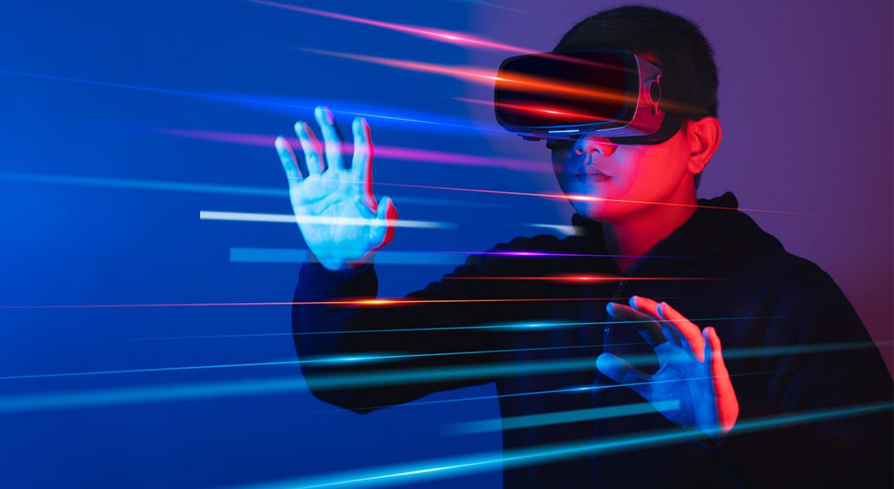 A young man uses a VR headset in a colorful environment