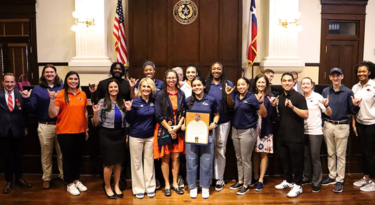 Head Coach Karen Aston represented UTSA at the Bexar County Commissioners Court on Tuesday as March 1 was proclaimed “UTSA Women’s Basketball Day.” Student-athlete Cheyenne Rowe (left) and Associate Vice President for Community & Government Relations Albert Carrisalez (right) looked on.