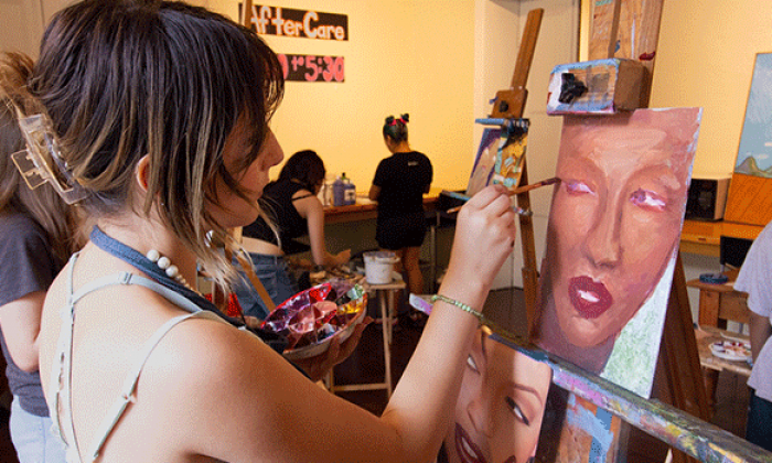 Student painting on canvas